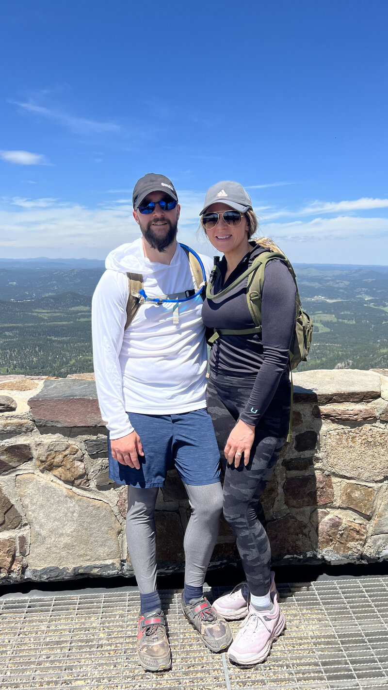 husband and wife during hike at black elk peak south dakota
