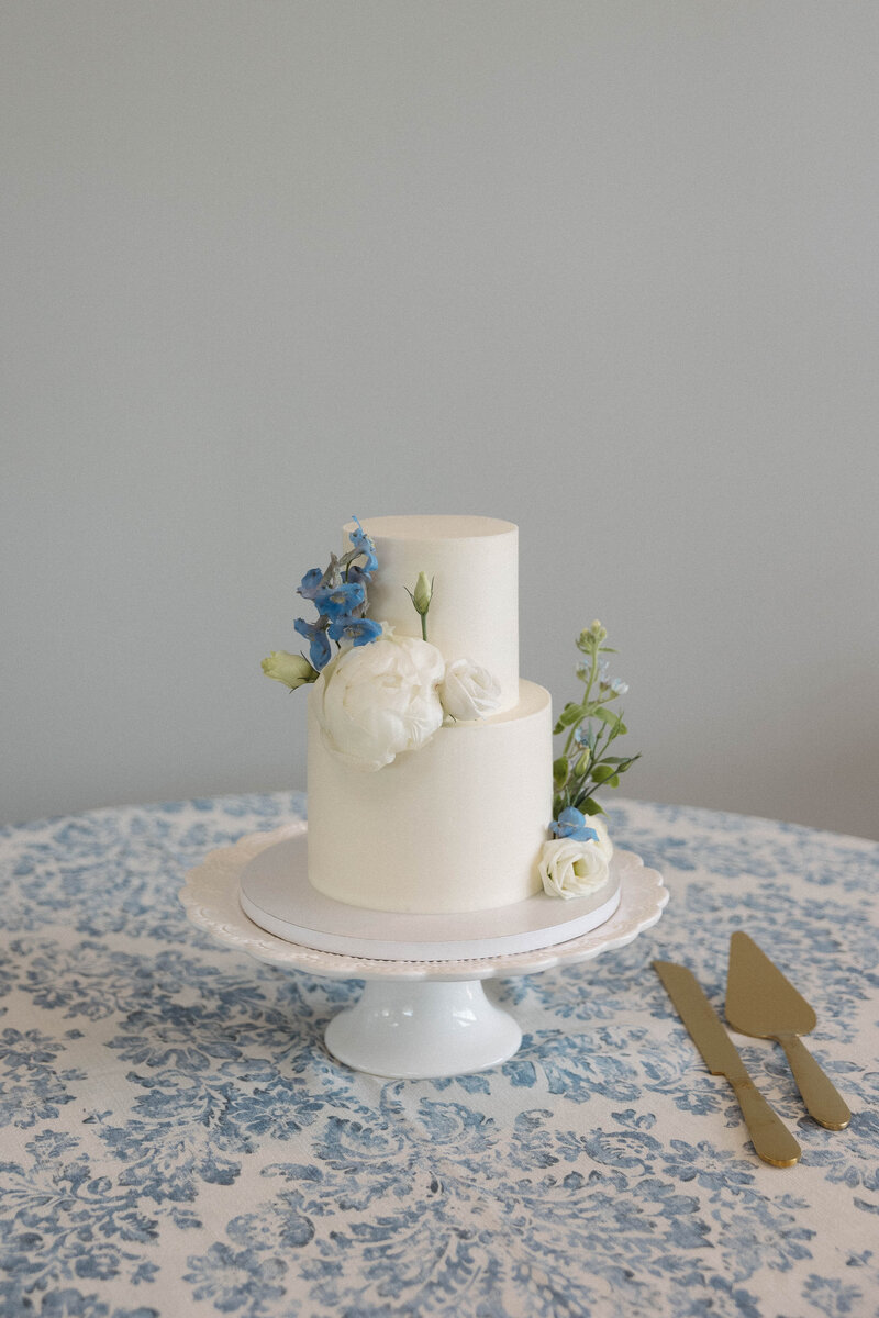 wedding cake with blue floral table cloth