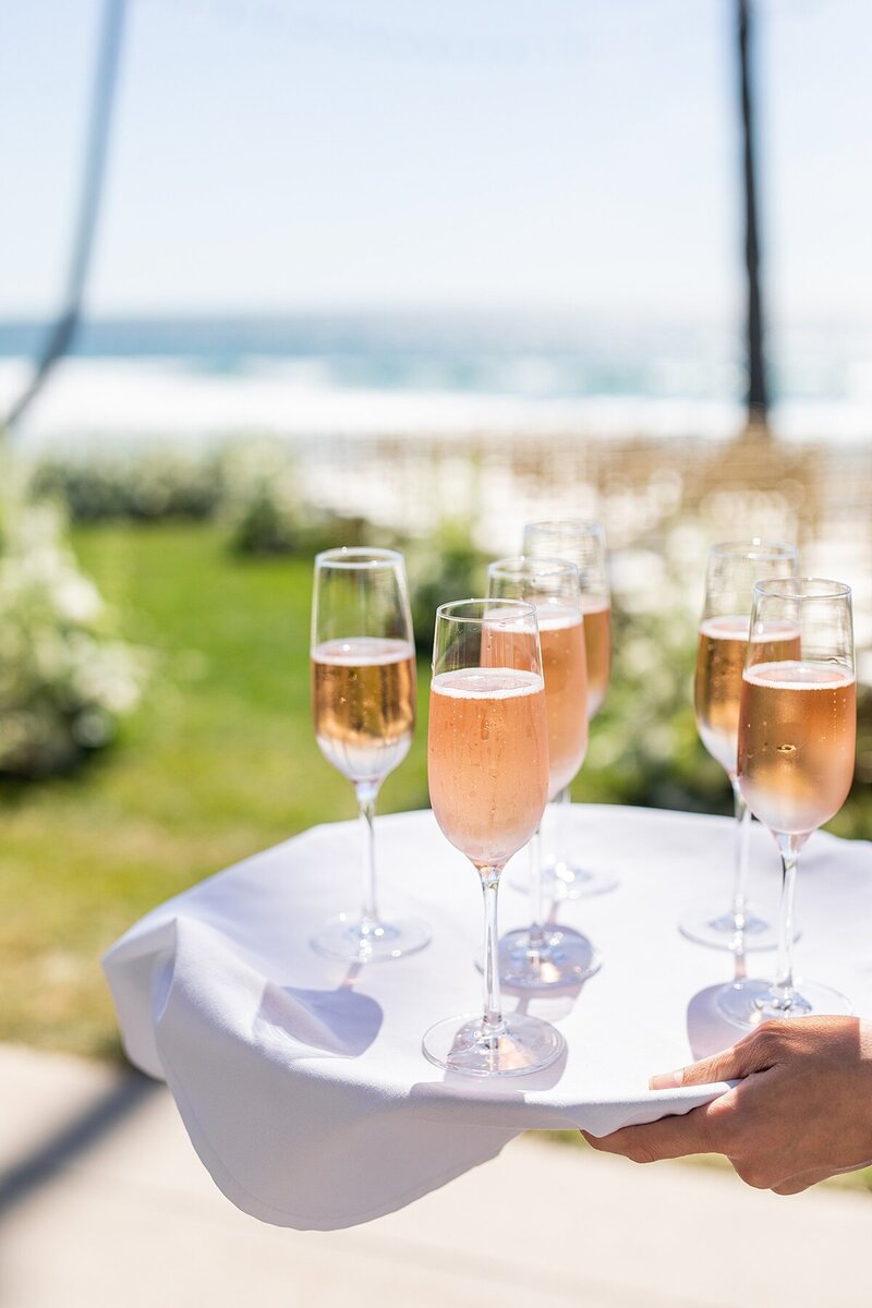 Pre-ceremony champagne to greet wedding guests at Scripps Seaside Forum in La Jolla, California, by Hayes and Bree Sherr, Photography and Videography.
