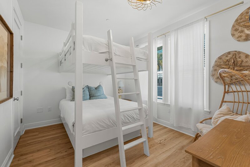 Cozy queen bunk bed setup with coastal decor at Beach Cabana, a vibrant Panama City Beach vacation rental perfect for families and friend groups.