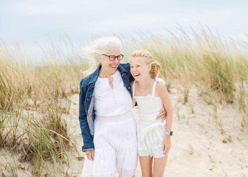 Grandparent and grandchild laughing at the New Jersey shore.