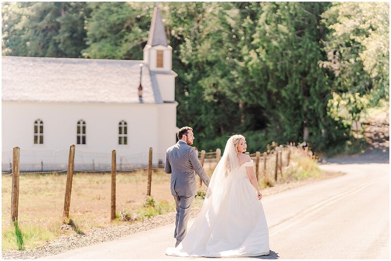 Bride and groom walking down the road by Portland Oregon Wedding Photographer