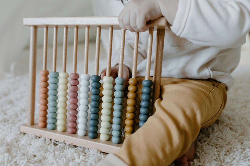 Young baby playing with wooden abacus