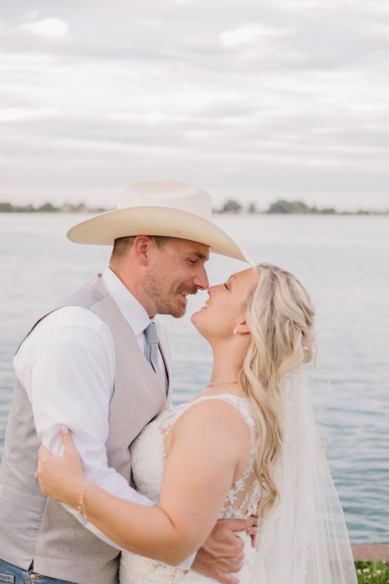 bride and groom by the water