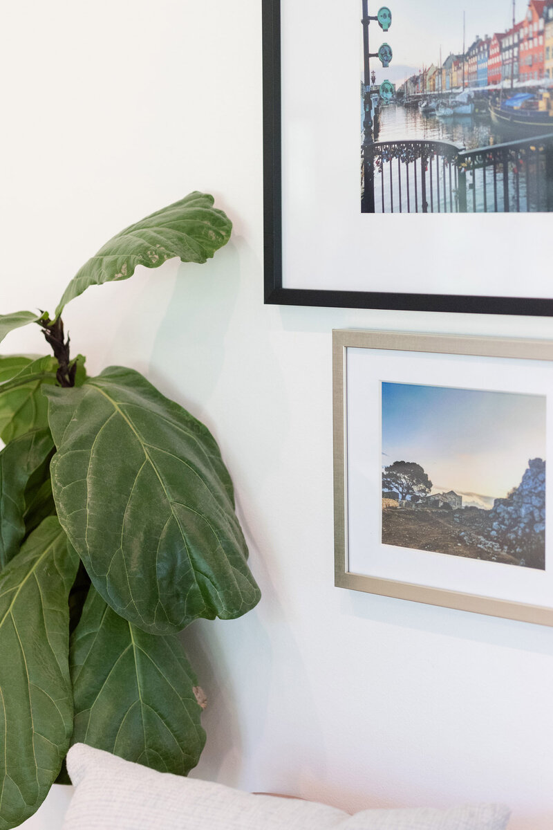 Framed travel photos on the wall