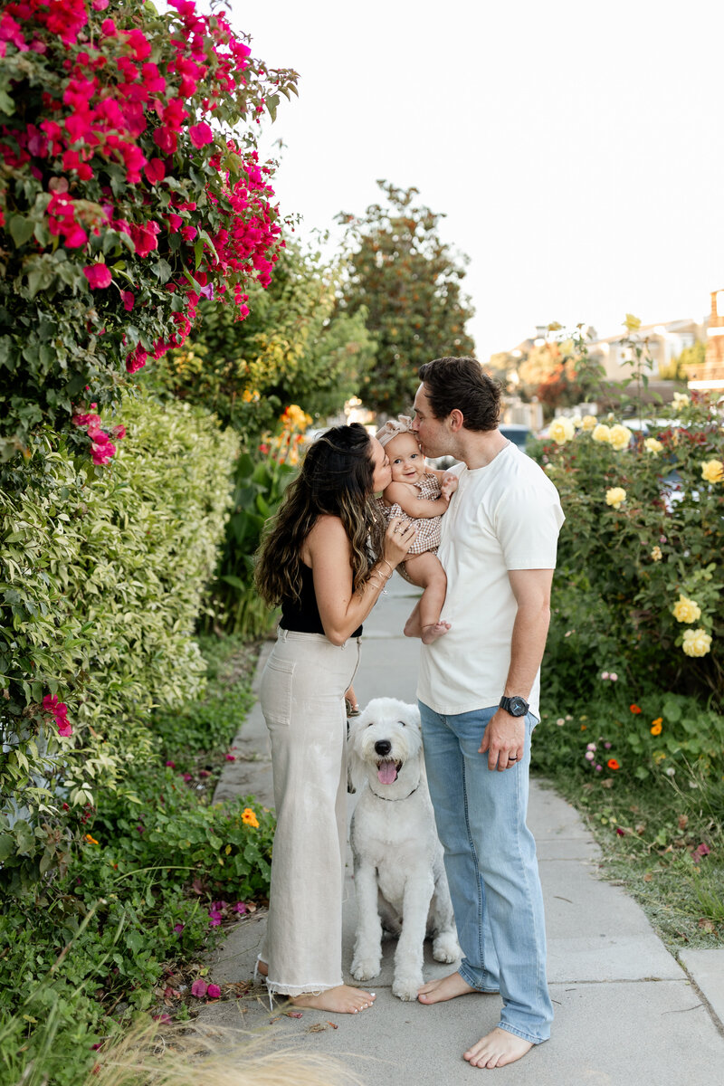 family kissing baby