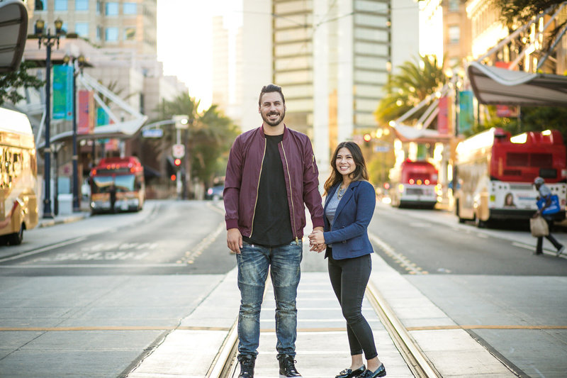Newly engaged couple standing in crosswalk in  downtown Long Beach