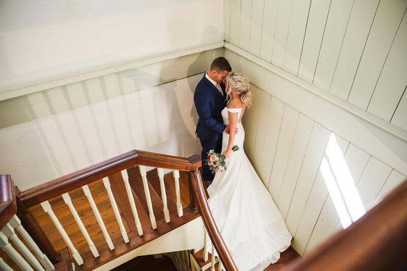 couple kissing in corner on stairs