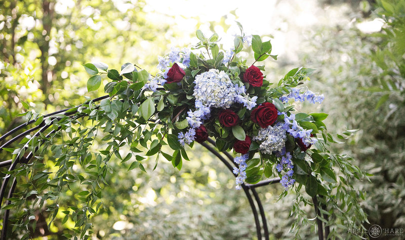 Pretty hydrangeas decorate a wedding arch for a wedding in the gardens at Greenbriar Inn in Boulder