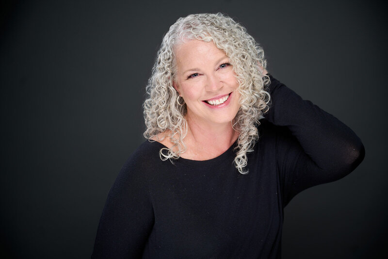 Elegant Portrait of a Smiling Woman Over 40 With Curly Gray Hair-158