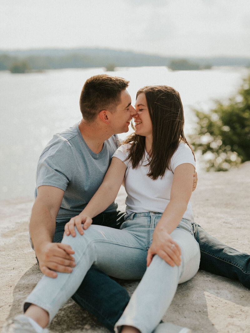 Engaged couple during a romantic session by the water in New York, captured by NYC wedding and elopement photographer Dom Augustine.