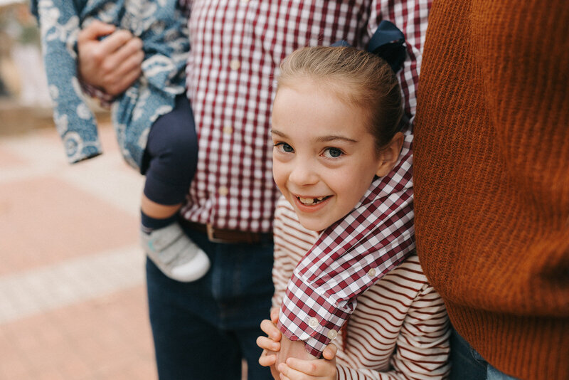 Little girl looking up at the camera during family portraits