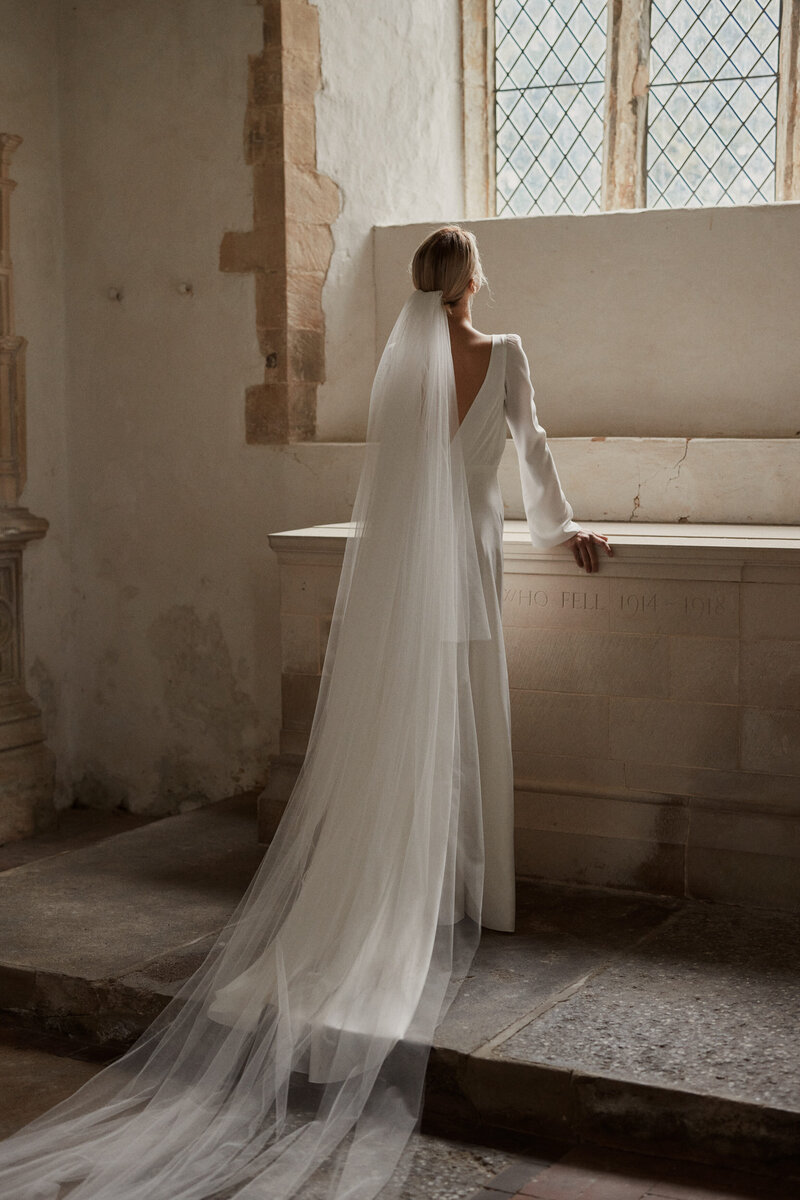 Deep v back silk wedding dress on natural bride in church