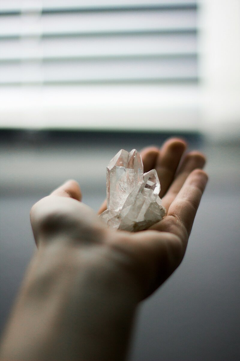 Woman holding crystals by the window