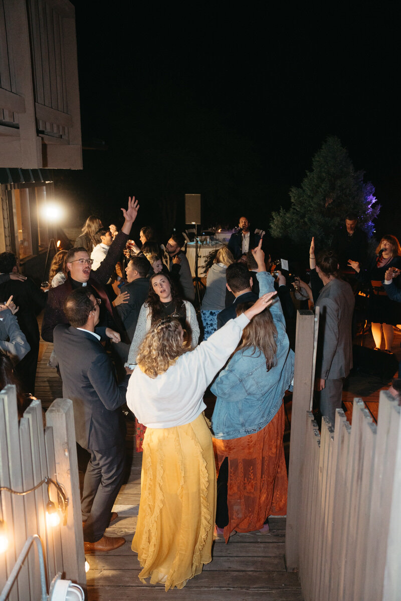 Eloping Ideas | Elopement guests all dance around a bride and groom during their elopement reception
