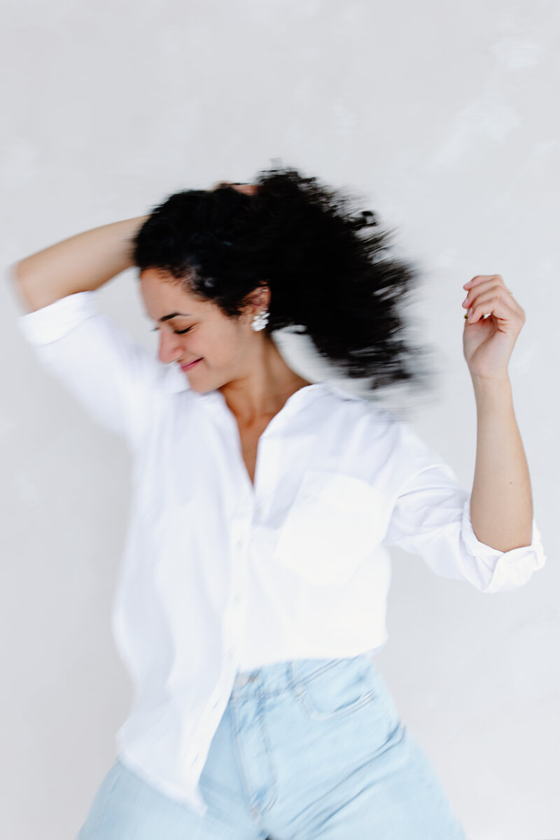 Photographer, Teresa Williams, dances and shakes her hair