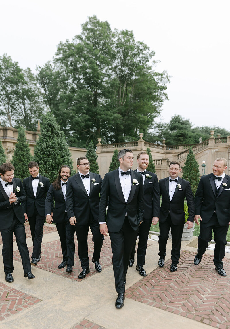 groomsmen-walking-black-tuxedos
