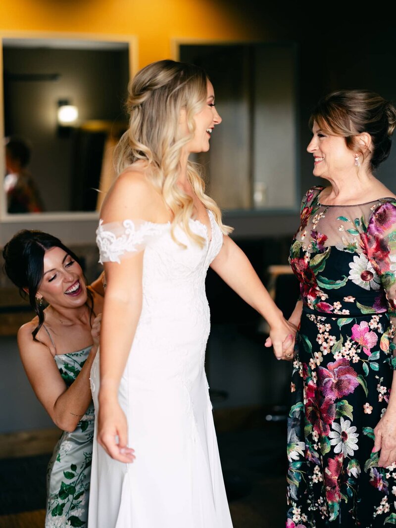 bride getting dressed on wedding morning