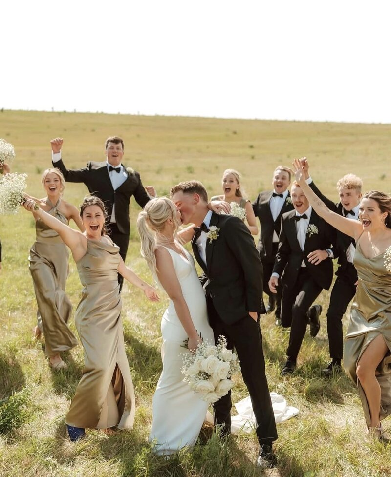 A fun and memorable photo of the bridal party at a wedding hosted at the August House Venue.