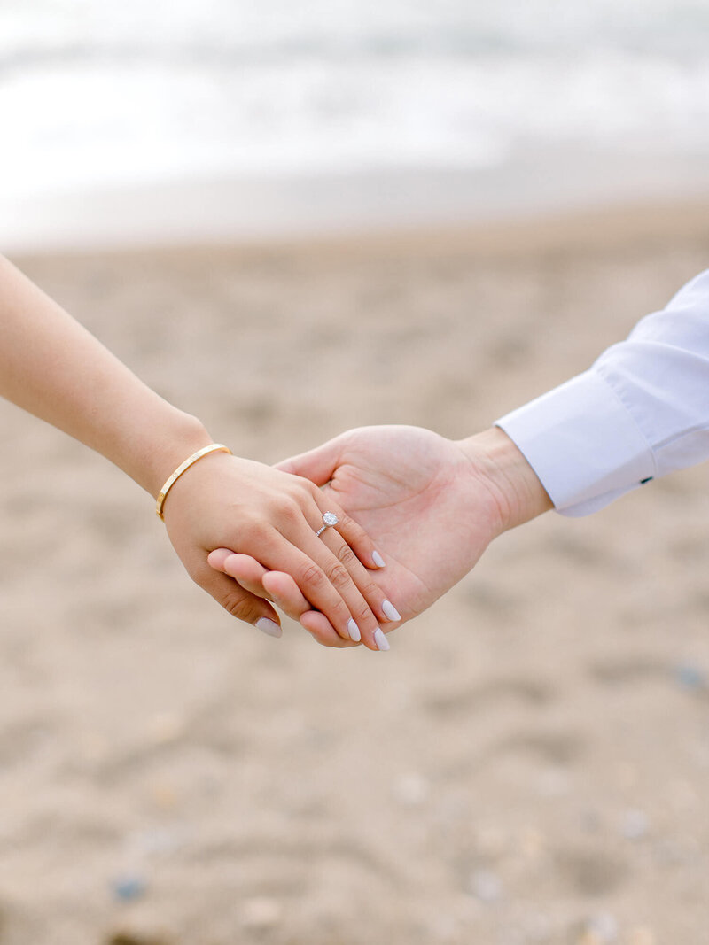 engagement ring macro shot of couple's hand