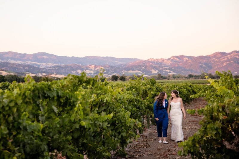 two women walk on their wedding day at a winery in sonoma california
