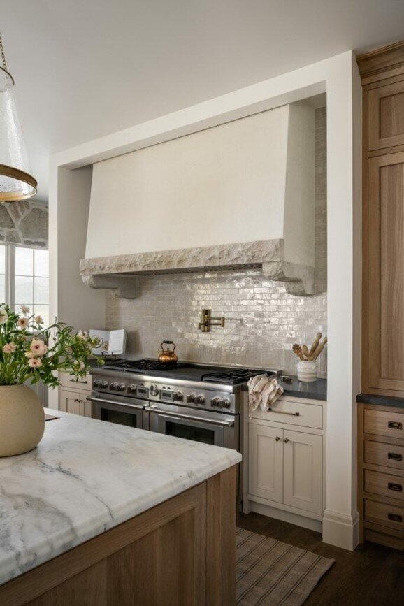 A modern kitchen featuring elegant marble countertops and a spacious central island for cooking and dining.