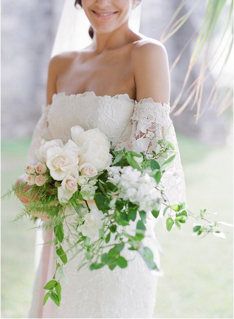 Bride holding bridal bouquet in wedding dress