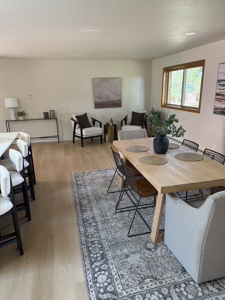 Modern dining room with wood table, soft lighting, and neutral tones designed by KSC Interiors.
