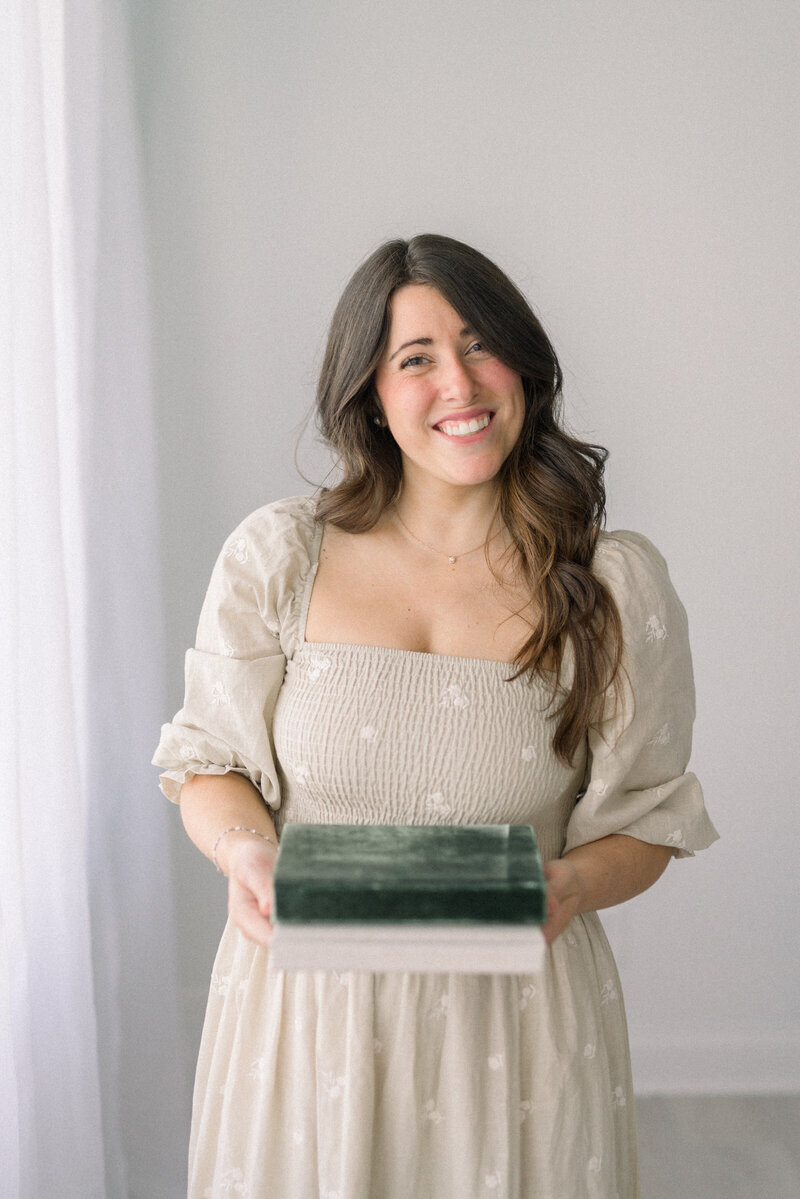 women holding heirloom photo albums knoxville tennessee newborn photographer