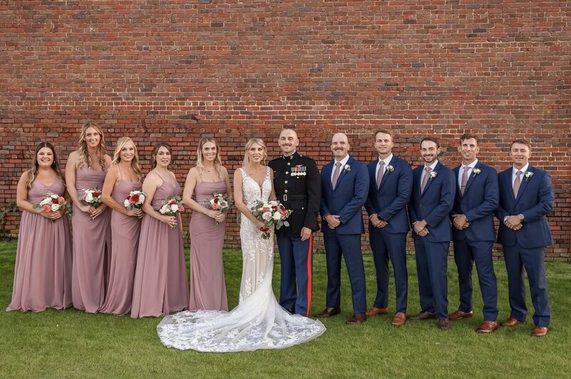 event venue couple at Palafox Wharf Waterfront  Wedding Party with Brick Wall