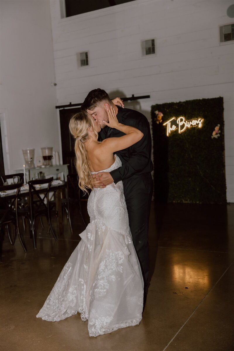 Indoor wedding ceremony in a beautifully decorated venue in Wyoming, with a couple exchanging vows under soft, romantic lighting.