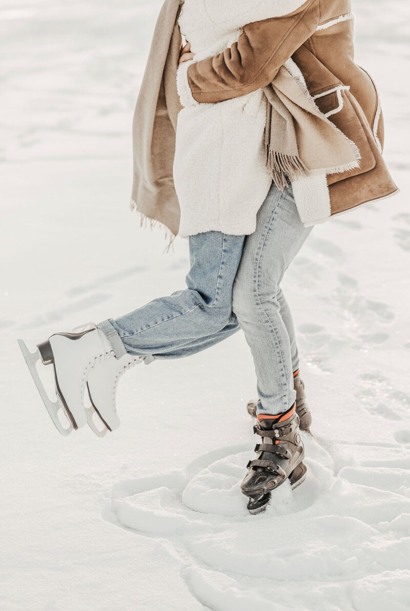 color image of couple  iceskating one is twirling the other