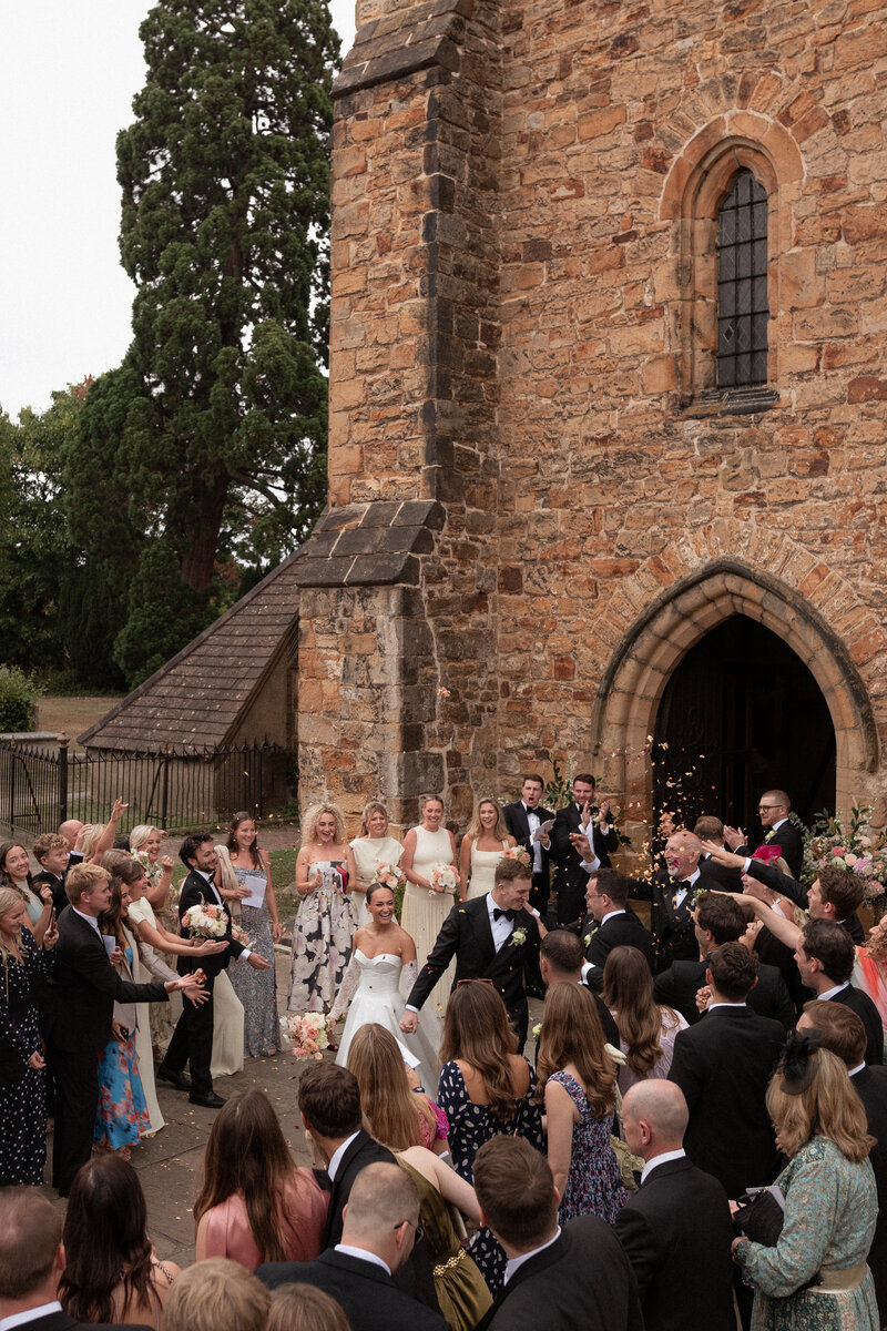 Wedding photographer captures couple taking a stroll hand in hand at their french chateau wedding.