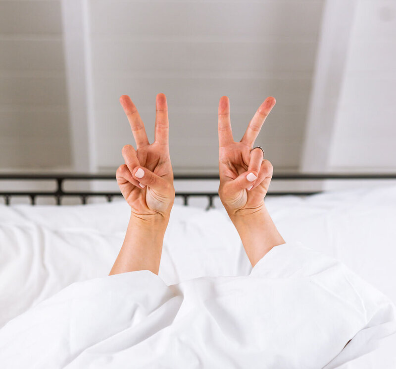 Peace in bed - hands up Crystal Oliver Creative Agency Melbourne