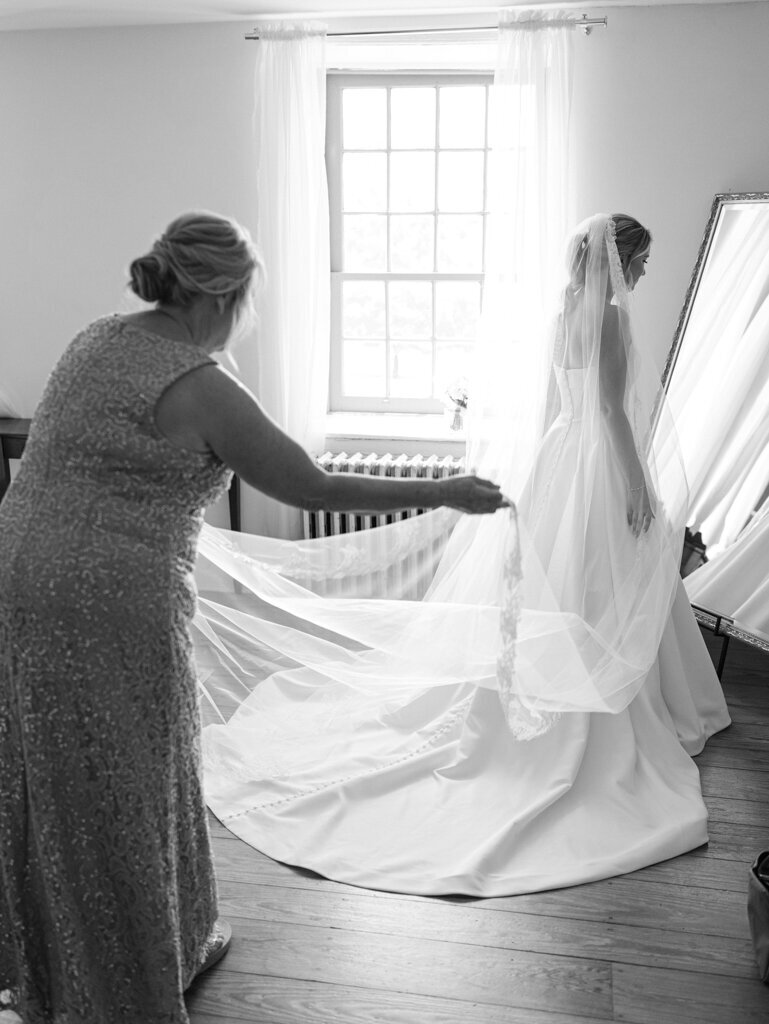 mom helping daughter get ready taken by one of the top baltimore wedding photographers