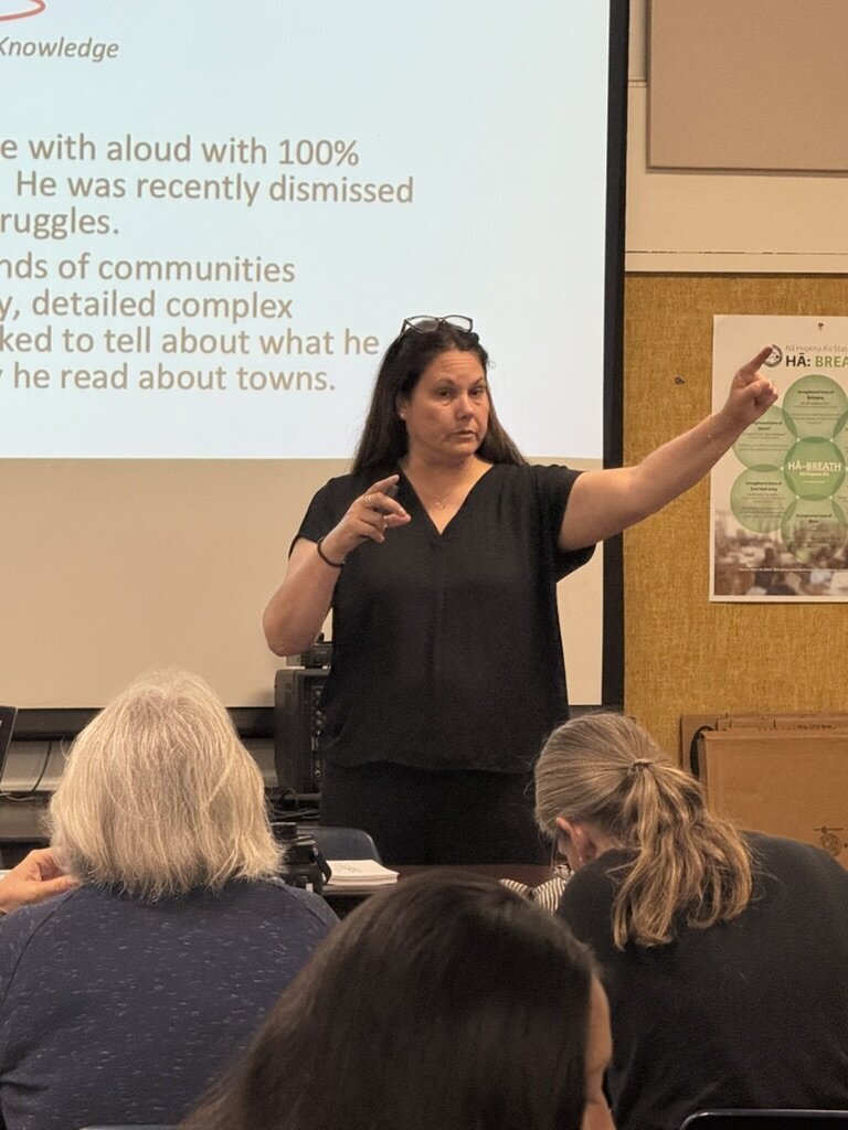 literacy consultant speaking on stage at a conference breakout session