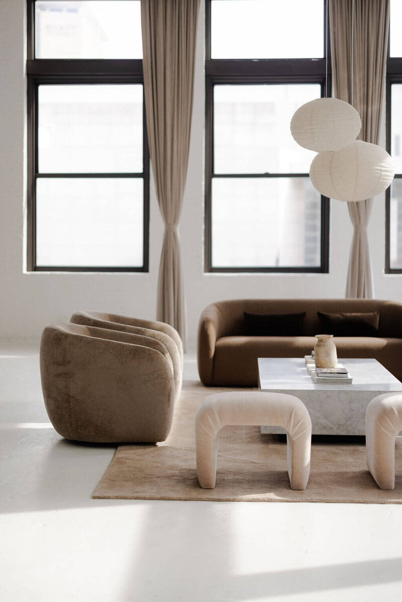 Neutral, modern furniture filling a loft space that is used for photo and event rentals. 