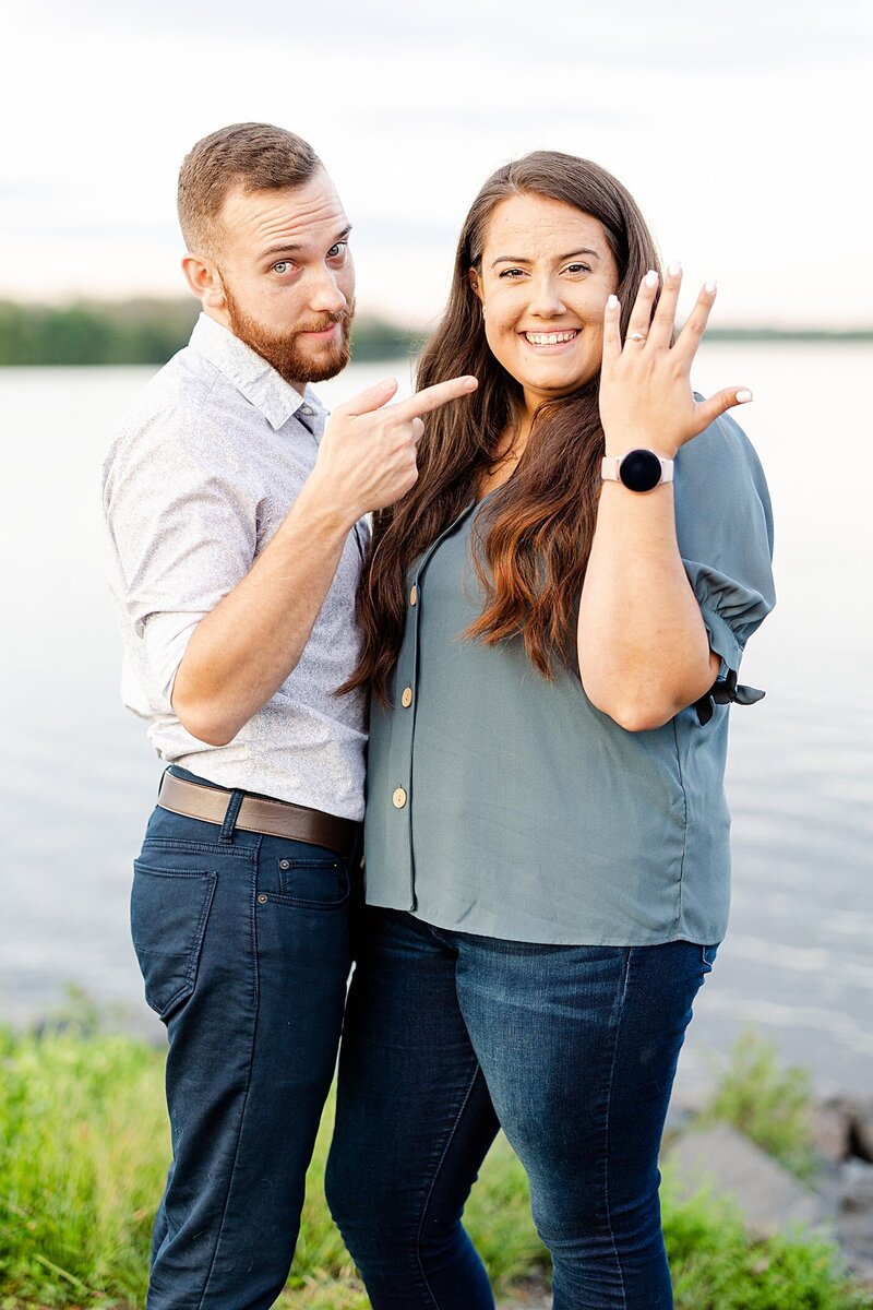 A couple showing off the ring  at a surprise proposal at a park in Pennsylvania.