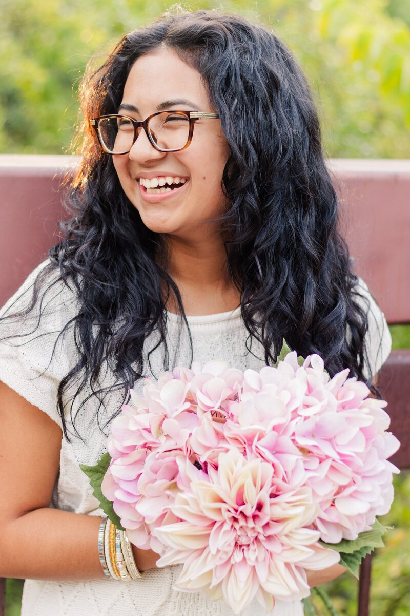 Senior Girl with flowers laughing