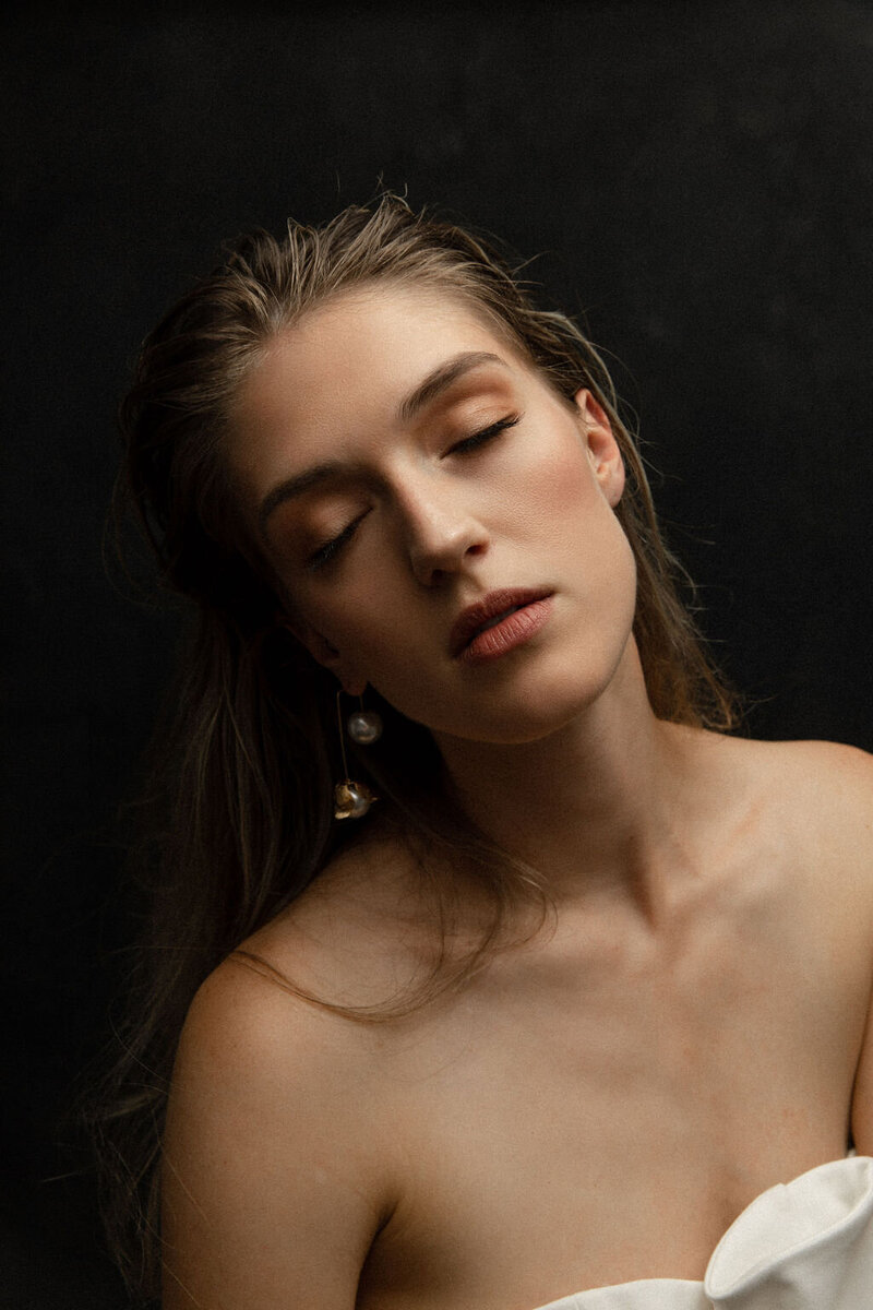 Closeup of a bride with her hair down and eyes closed