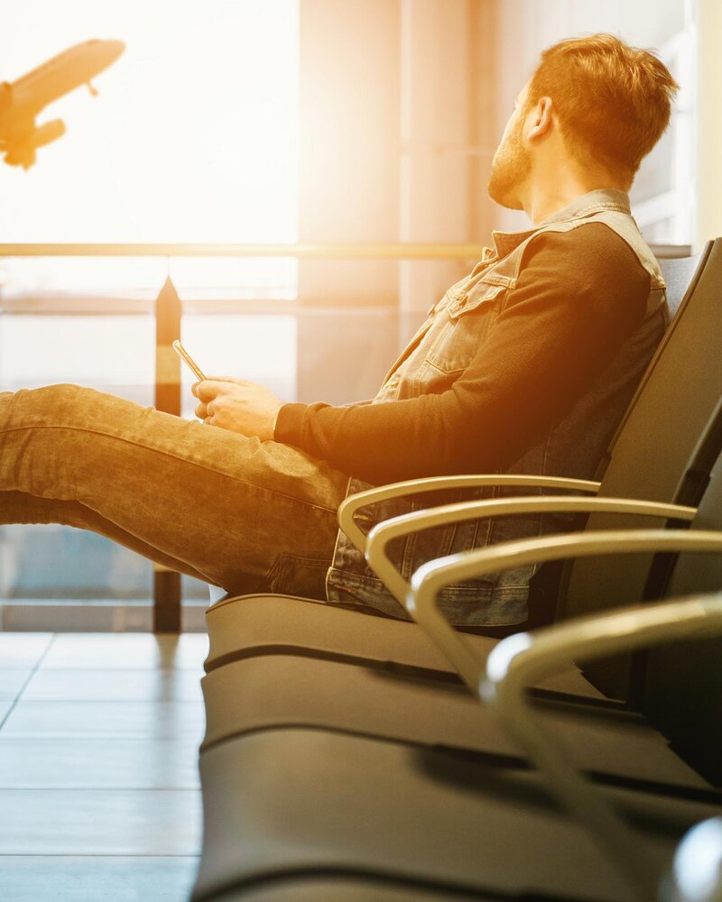 Man sitting in airport, St. Pete Rejuvenate Jet Lagged IV Infusion