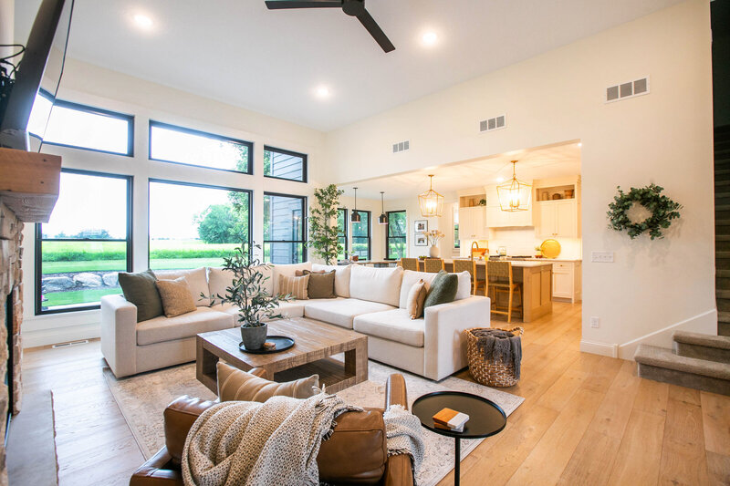 Bright and spacious living room in a Otsego forever home featuring natural light, fireplace, and custom design elements by Cornerstone Custom Builds