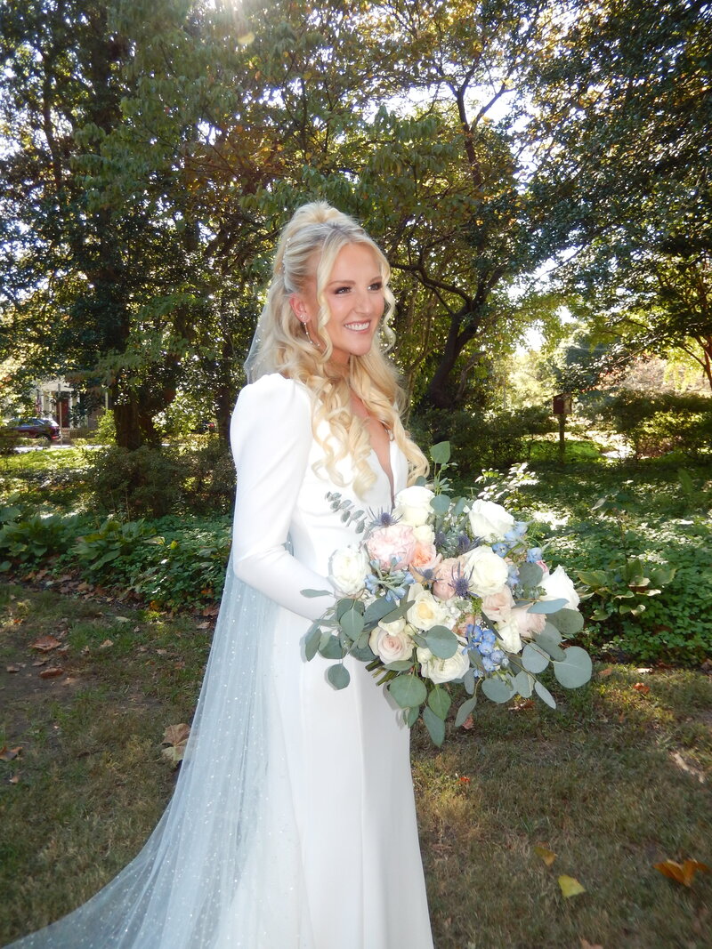 Dawn holding her wedding bouquet with a happy smile on her face.