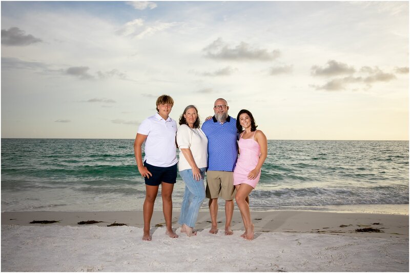 A family of four with teenage kids on the beach