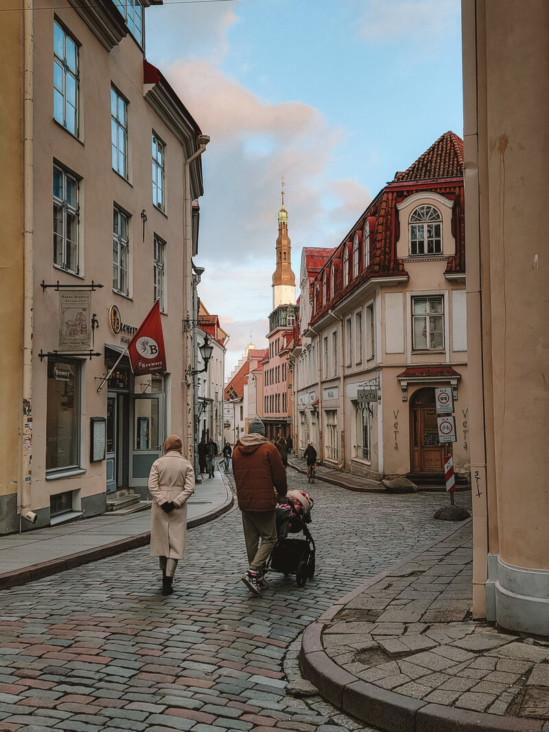 A couple walking in the streets of Tallinn's old town in Estonia at sunset