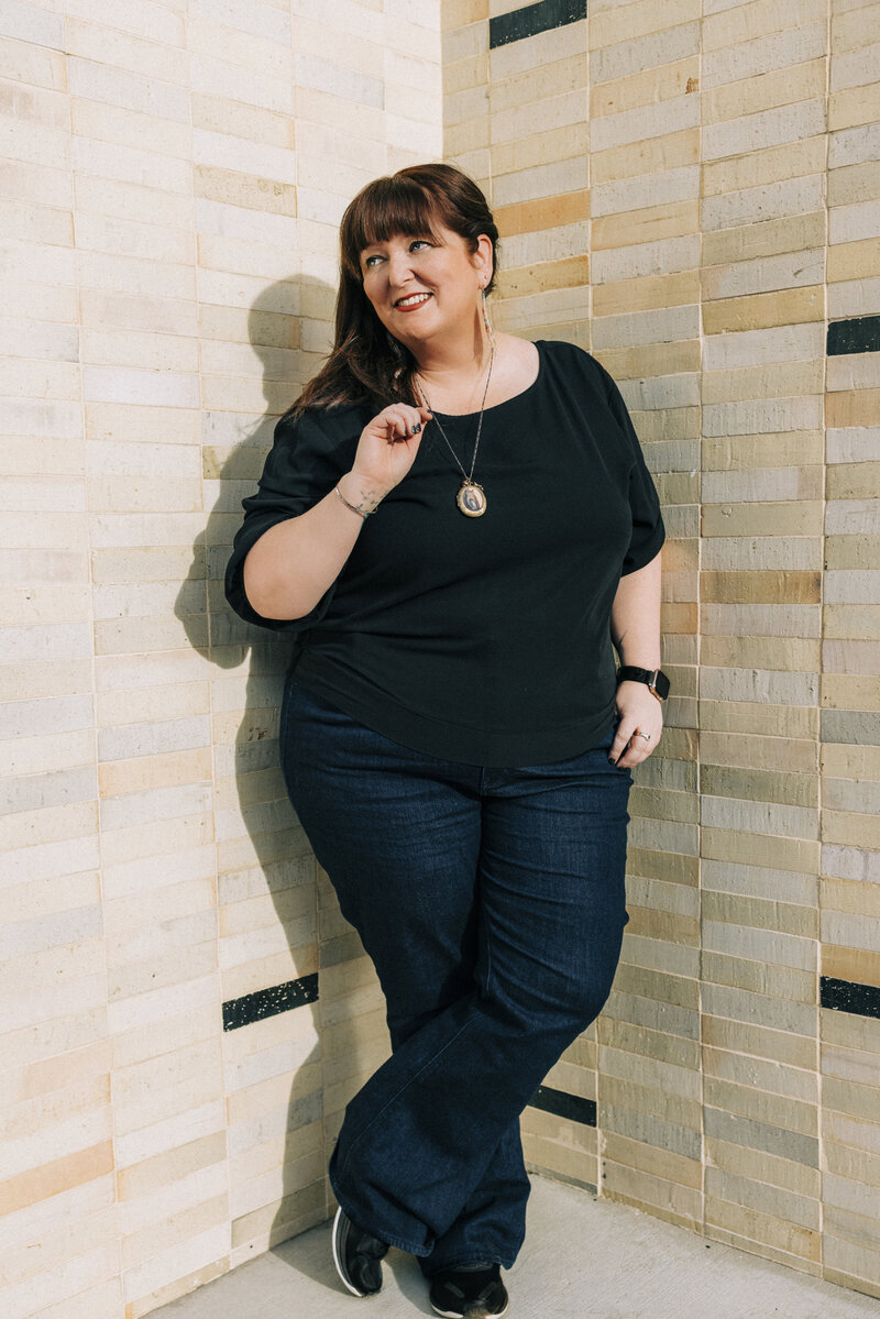 Amy Wiilliams standing infront of a beige tiled wall in Palm Springs.