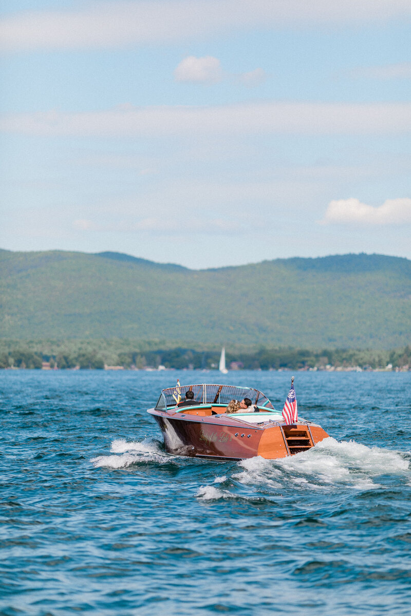 Small boat on the water with mountains on the horizon
