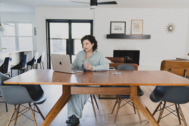 Desiree Peterson on her office sitting while on her laptop