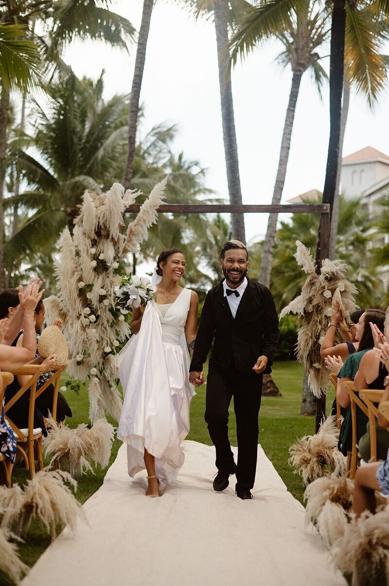 Couple smiling and posing at their wedding ceremony