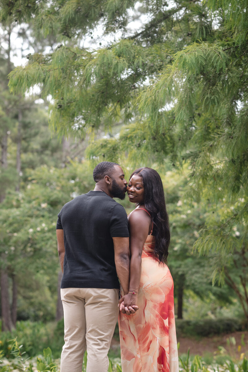 Charlotte proposal photographer captures joyful moment of engaged couple at Glencairn Gardens in Rock Hill, SC during a surprise engagement session.
